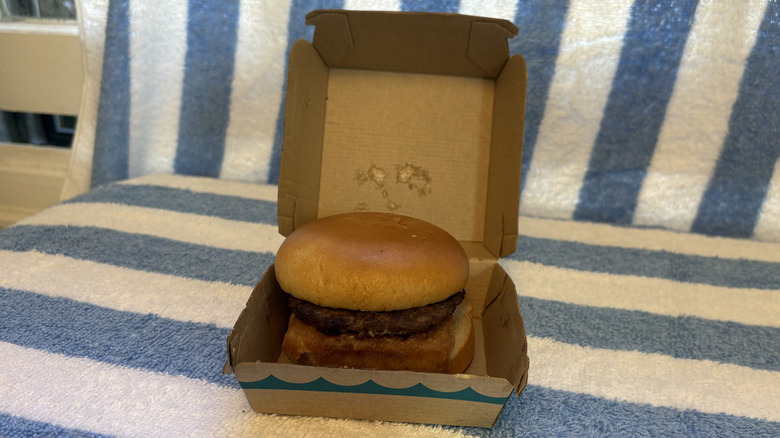 A Filet-O-Fish sandwich with an added beef patty, sitting in its box