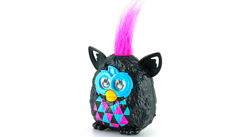 A Mini Furbie on a white background