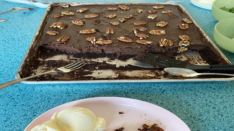 Texas sheet cake in a pan with pecans on top