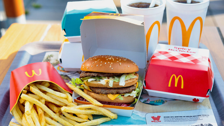 McDonald's fries, Big Mac, Spicy McChicken, and drinks on a tray