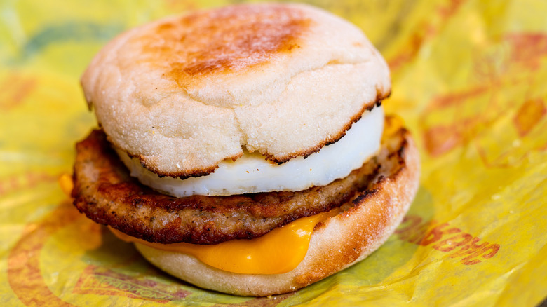 A McDonald's sausage McMuffin sitting on the wrapper