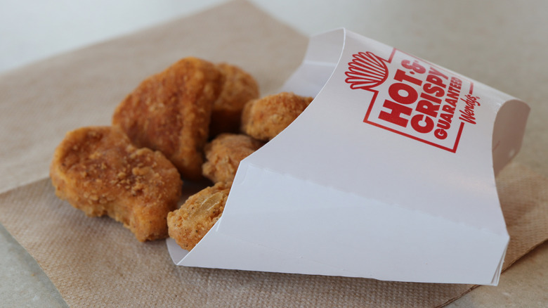 Wendy's chicken nuggets spilling out of a container on a napkin