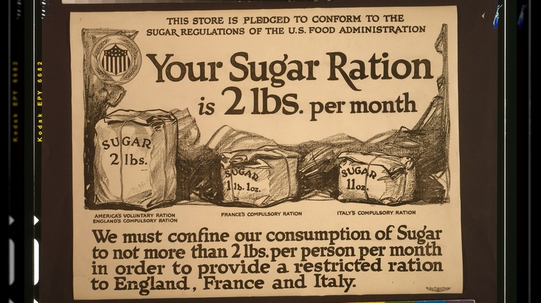 Sepia photo of a sugar ration poster showing the differences between sugar allotments for citizens of the US, England, France, and Italy