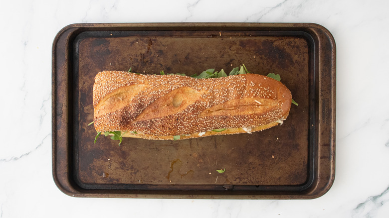 A large tuna salad sandwich secured with toothpicks