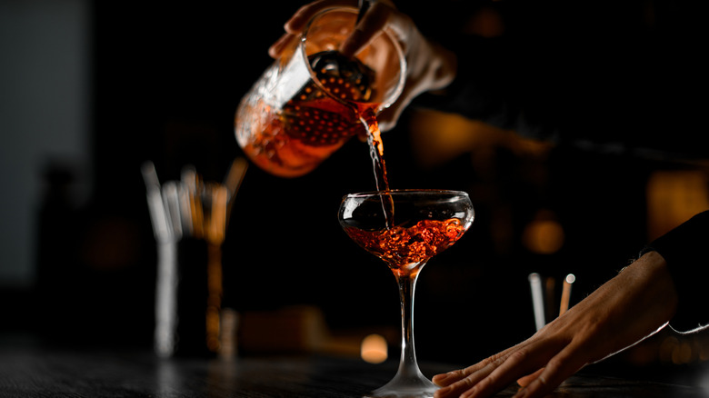 Close up of a bartender pouring a drink.