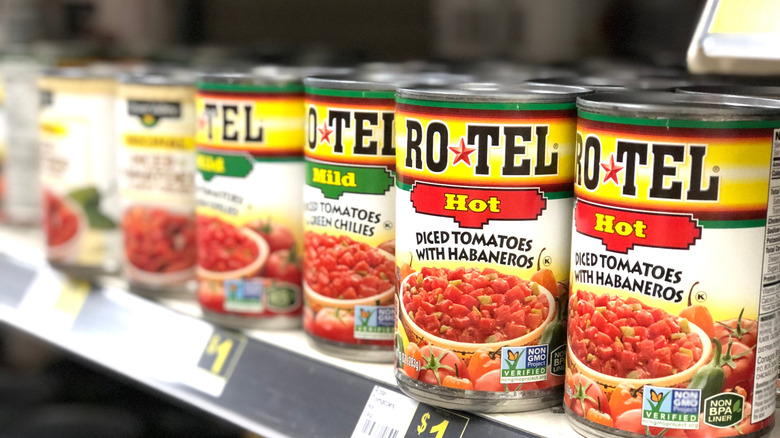 Cans of Rotel diced tomatoes taken from a grocery shelf