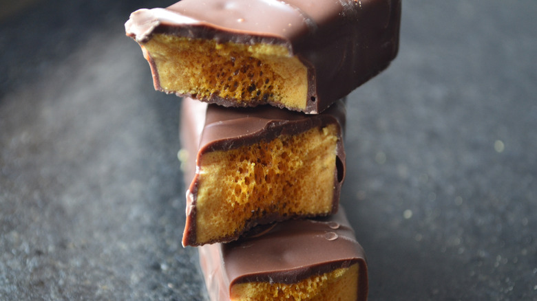 Close up of three chocolate candies with sponge center