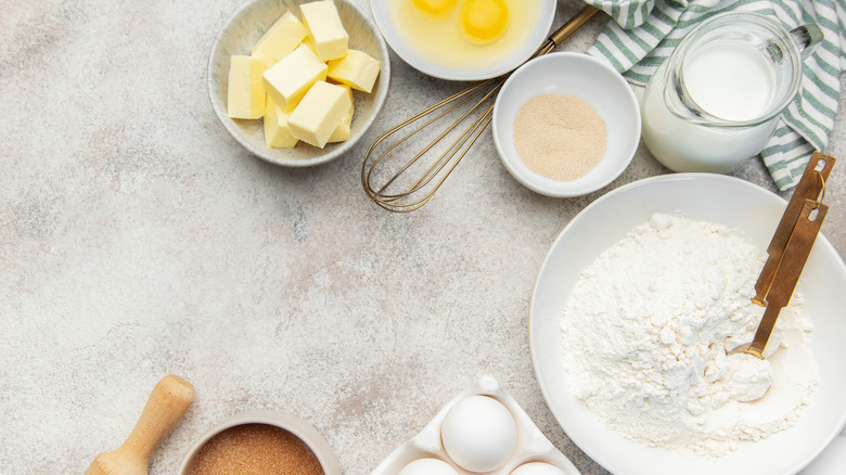 Assorted baking ingredients and kitchen materials on kitchen counter.