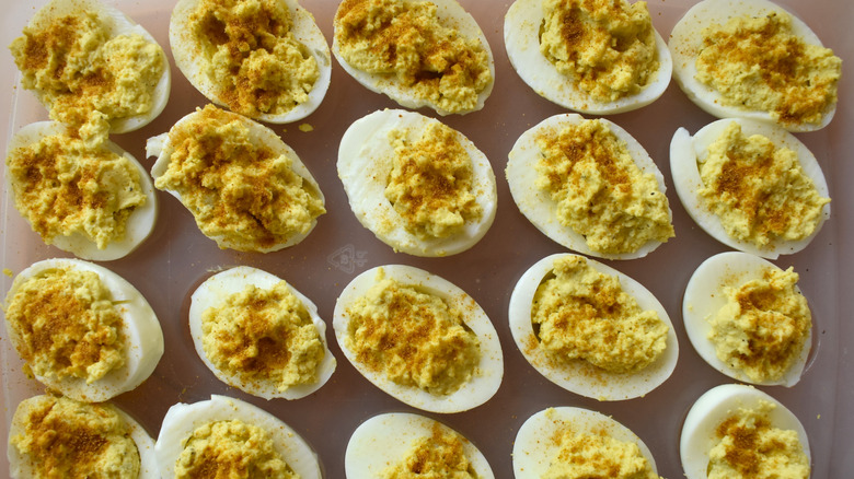 Selection of homemade deviled eggs topped with paprika.