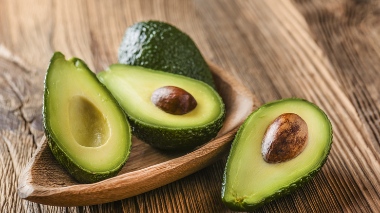 avocados in wooden bowl