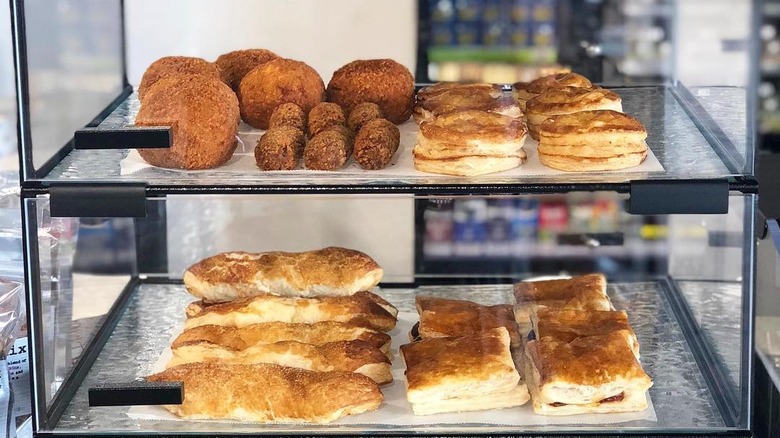 An array of baked goods in a glass cabinet at Mendez Fuel.