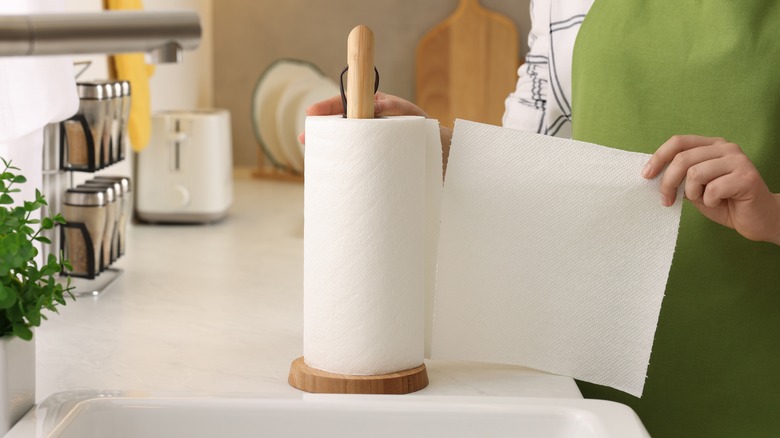 person tearing a paper towel