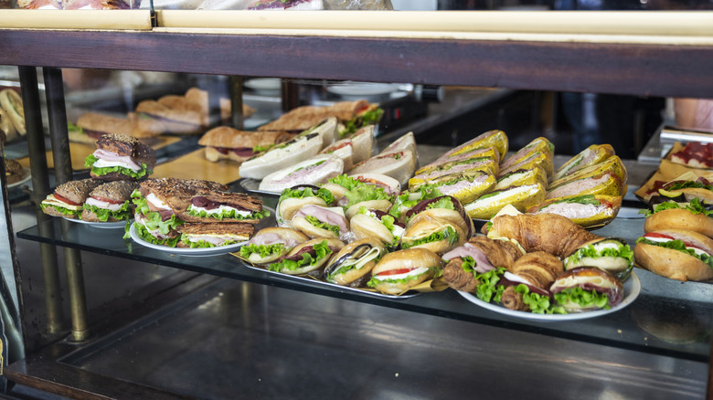 A glass display where you can see an array of Italian sandwiches.