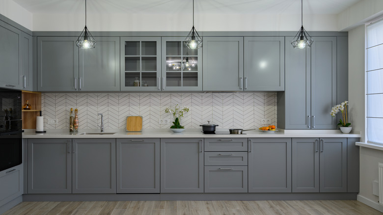 Millennial gray kitchen with white countertops and backsplash