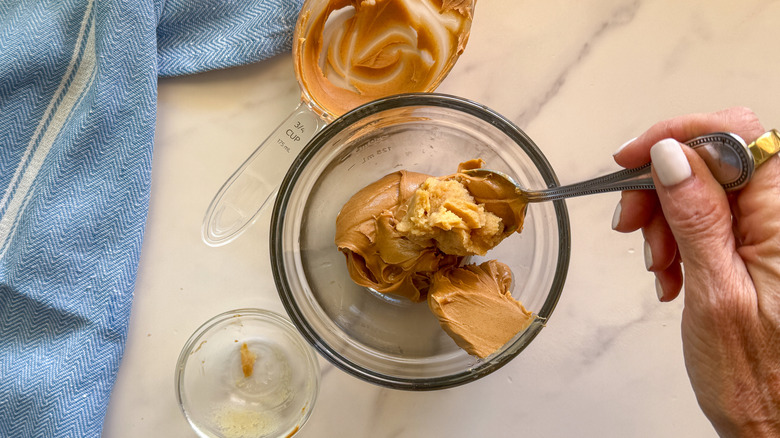 hand mixing miso and nut butter