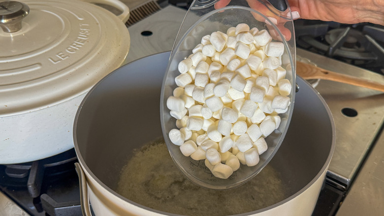 pouring marshmallows into pot