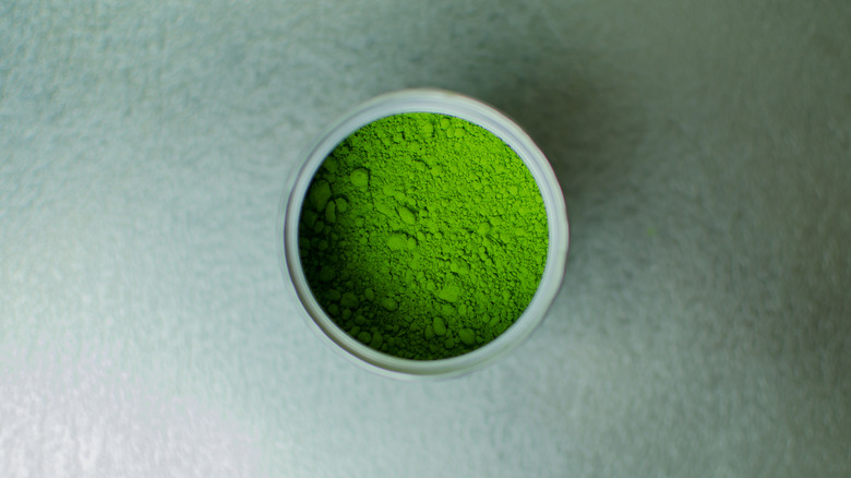 Matcha powder in a small tin