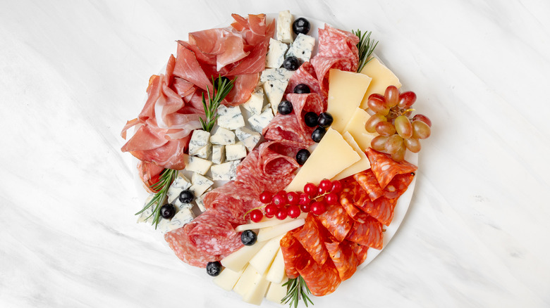 folded meats on a charcuterie board