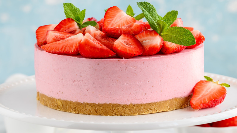 No-bake strawberry cheesecake on a stand.
