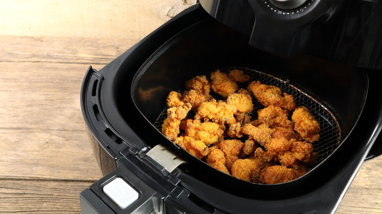 Lots of breaded chicken in air fryer basket
