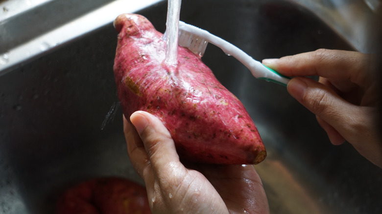 Red sweet potato being washed