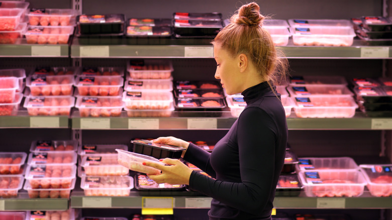 Woman selecting meat at store