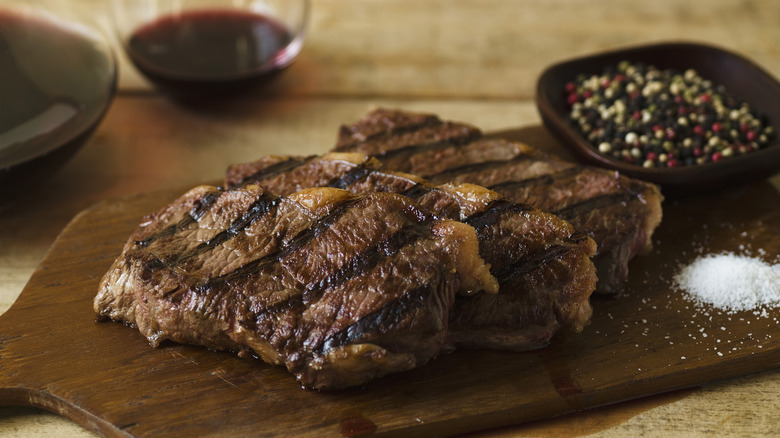 Steak resting on wooden board