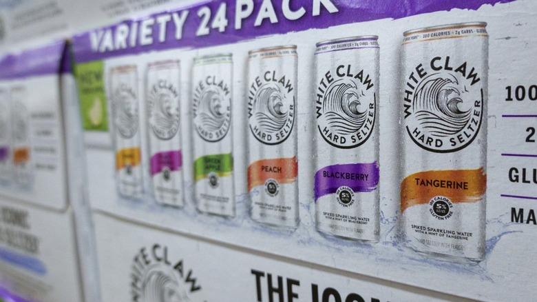 A variety pack case of White Claw with six different flavors for sale in a store.