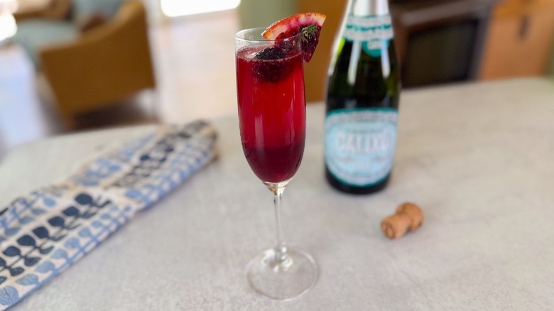 Mixed berry blood orange mimosa on countertop