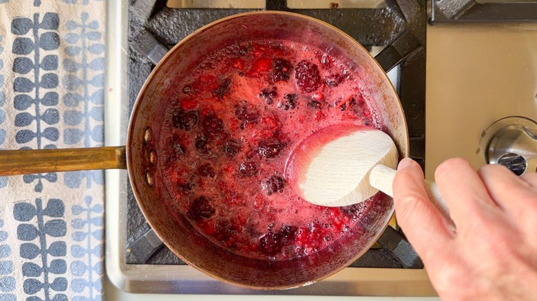 Mixed berry syrup simmering in saucepan
