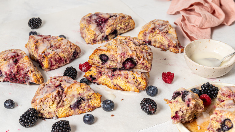 Mixed berry scones with fresh berries on table