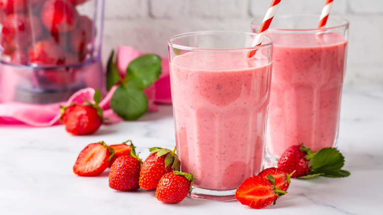 Strawberry milk in glasses with straws