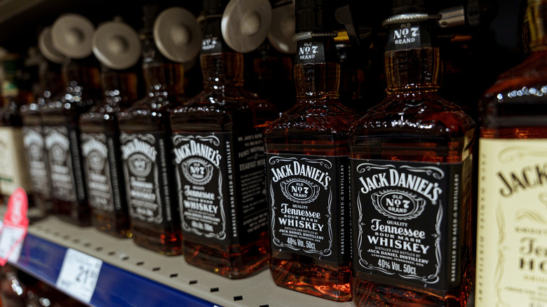 Bottles of Jack Daniel's whiskey on a store shelf.