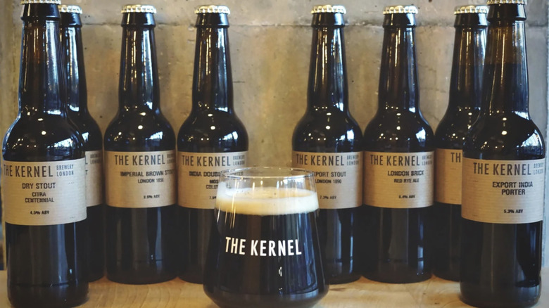 A glass of The Kernel Beer surrounded by bottles of variants