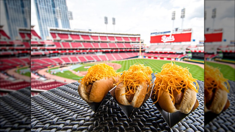 Three Cincinnati Reds hot dogs on table at Cincinnati Reds stadium.