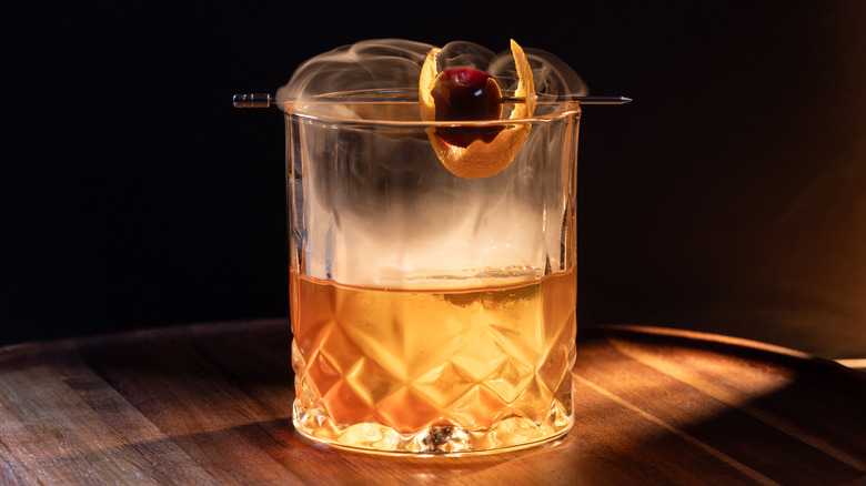 Old fashioned cocktail with smoke