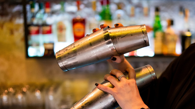 A bartender's hands shaking drinks