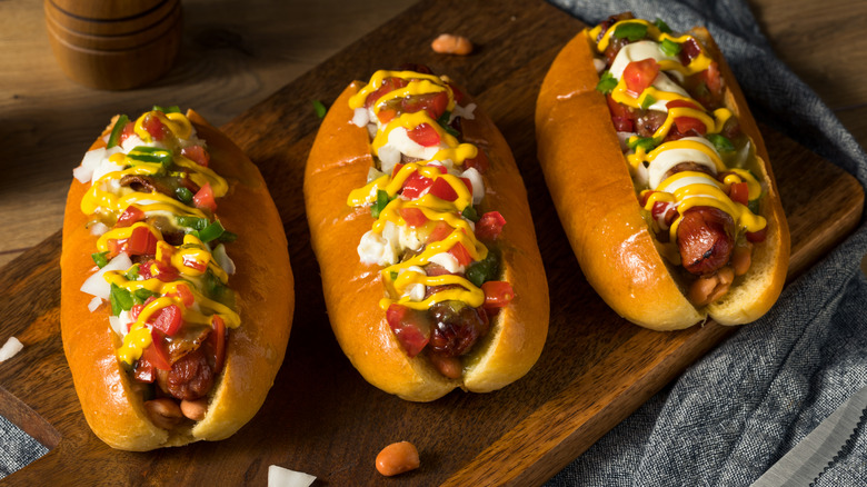 Sonoran hot dogs on a wooden cutting board