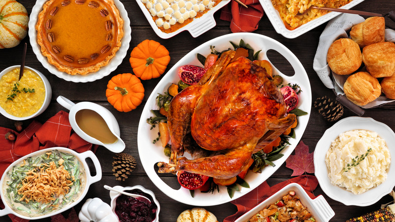 Thanksgiving spread with turkey at the center of the table