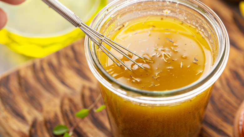 Mustard based vinaigrette in a glass jar.