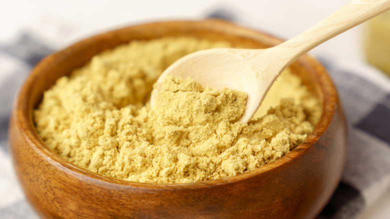 Mustard powder in a wooden bowl.