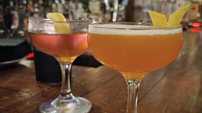 Two cocktails in coupe glasses at The Alley speakeasy in West Seattle.