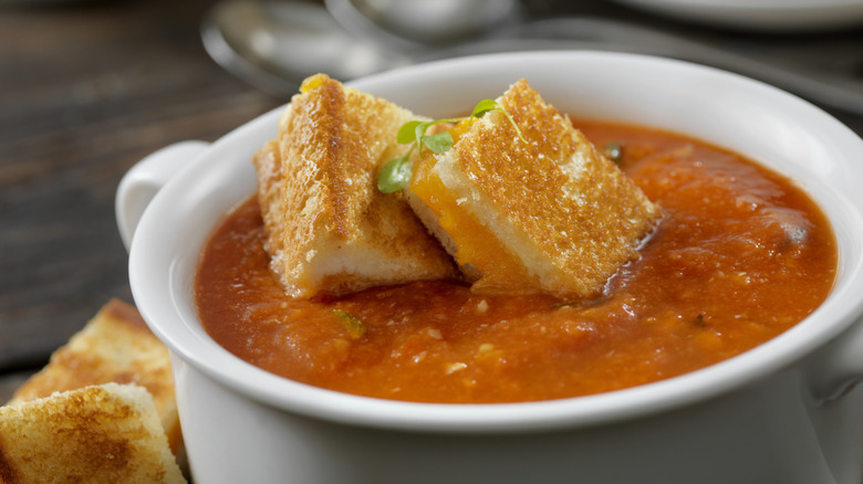 Cup of tomato soup with grilled cheese croutons