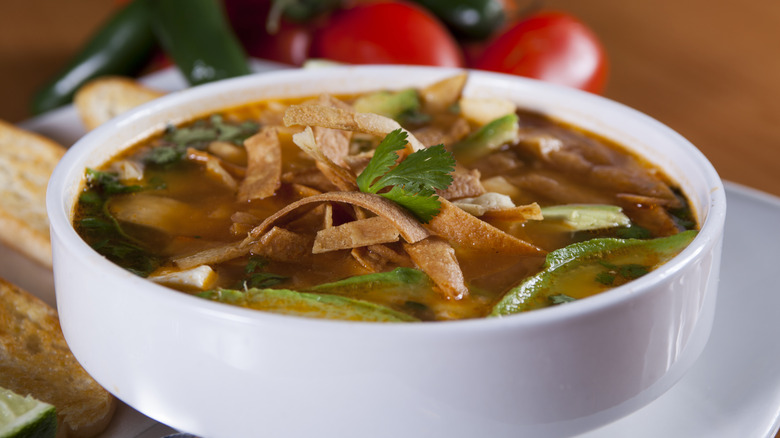 Tortilla soup in a white bowl