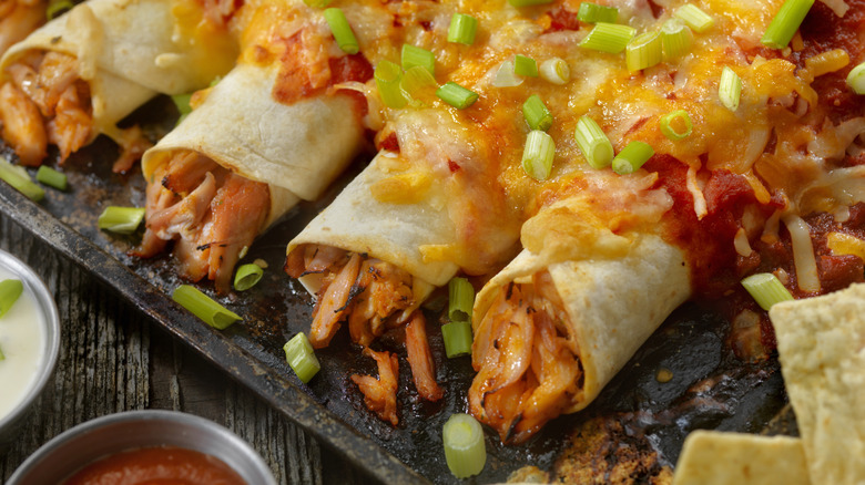 Chicken enchiladas topped with green onions