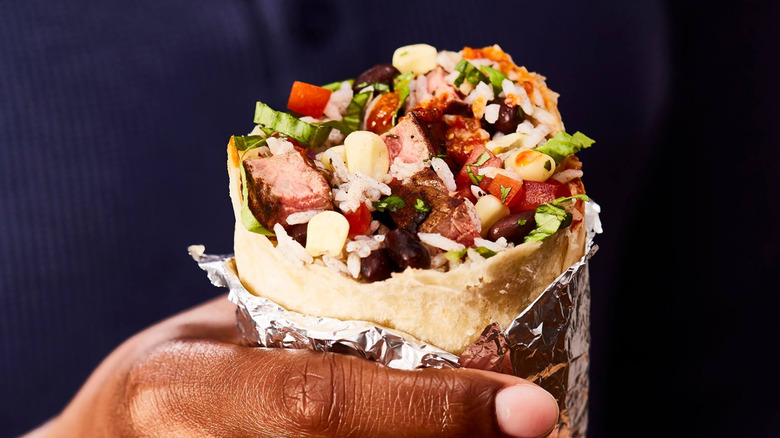 Person holding Chipotle burrito