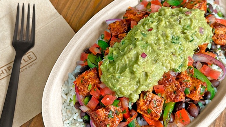 Chipotle chicken burrito bowl topped with guacamole