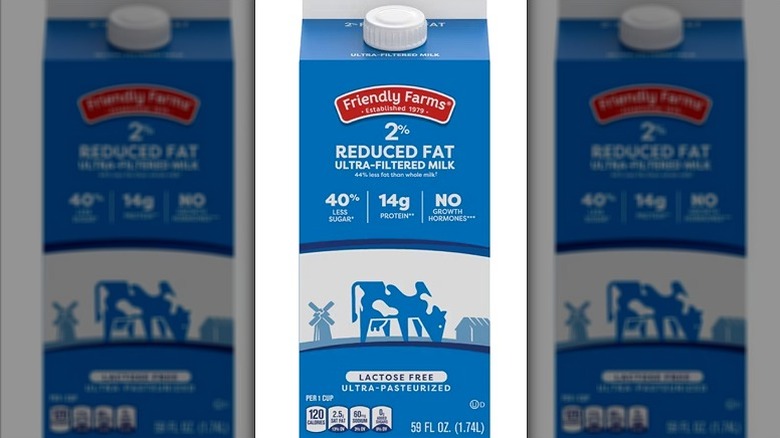 Aldi lactose-free reduced-fat milk on white background