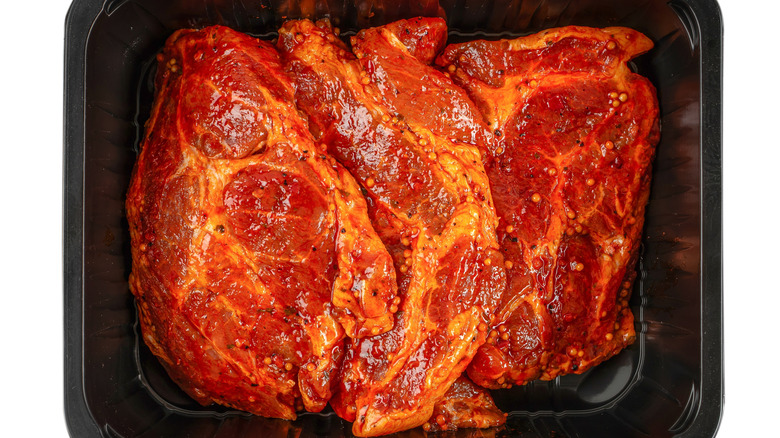 Beef steaks coated with marinade
