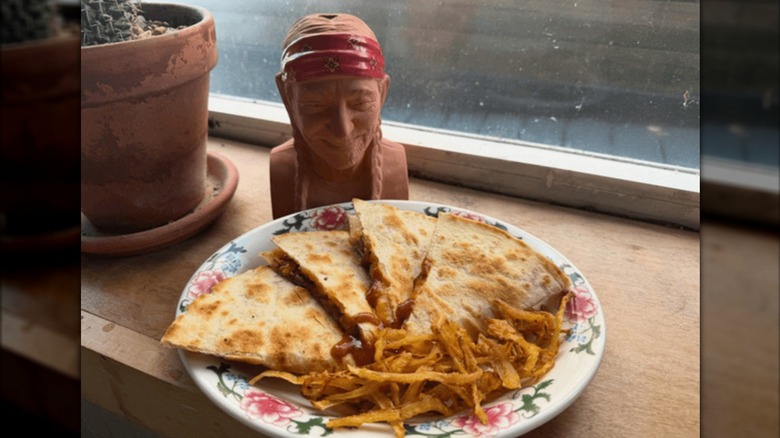 Willie Nelson statue looking at a quesadilla